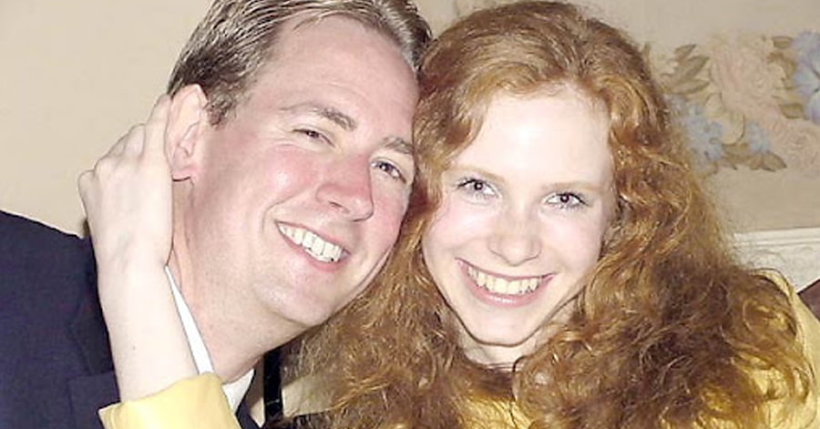 A foreign man and woman taking a picture together.